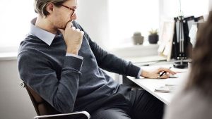 A man thinking at his desk - Wealth Connexion