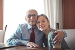 Woman with the elderly man smiling at the camera - Aged Care Financial Advice Image