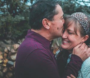 Elderly man kissing woman in forehead - Retirement Planning Image
