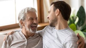 A Young Adult Man Hugging an Old Man - Wealth Connexion