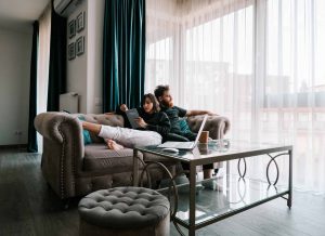 Young Couple sitting on a chair - Stop Losing and Start Making Money Image