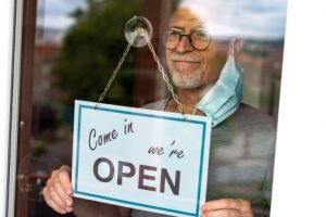 A Man Changing the Store Sign - Retirement - Wealth Connexion Blog Image