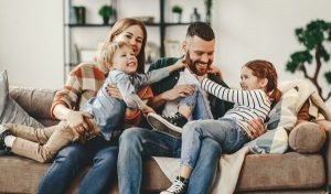 Family having a good time in living room - Emergency Funds - Wealth Connexion blog image