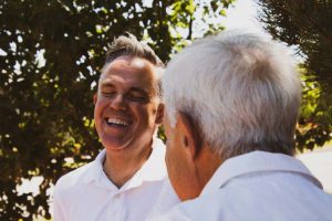 Two Men Talking and Laughing at Each Other - What Can Happen to Unplanned Aged Care - Wealth Connexion Blog Image