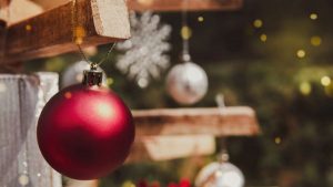 Close up shot of a Christmas ball hanging in a Christmas Tree - Wealth Connexion Blog Image