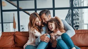 Family hugging at the sofa - Wealth Connexion