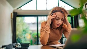 A woman being frustrated looking at her laptop - Wealth Connexion