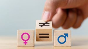 A male and female symbol block with an equal and unequal block in between - Men v women: Who pays more when it comes to insurance? blog image