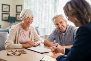 Two elder people talking to a financial adviser - Wealth Connexion