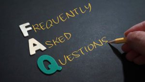 Frequently Asked Questions text with a person writing on it - Wealth Connexion blog image
