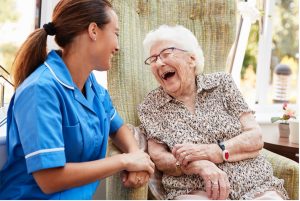 An old woman and her caretaker laughing - Wealth Connexion blog image