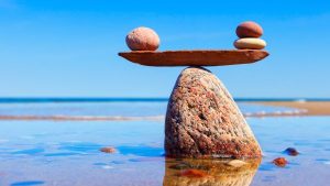 blocks of rocks balancing on a big rock - pros and cons of increasing super contributions - Wealth Connexion blog image