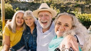 A group of elder people taking a groupie outdoors - Wealth Connexion blog image