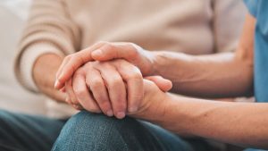 Two elder person's hand holding each other - Wealth Connexion blog image