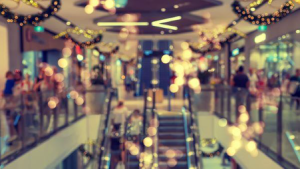 An out of focus photo of a shopping mall with christmas decorations - Wealth Connexion blog image