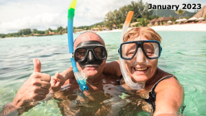Two elder couple on the beach waters with snorkels