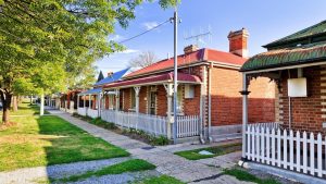 Houses built from bricks sidewalk and trees - Wealth Connexion blog image