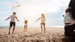 Family playing at the beach | Wealth Connexion blog image