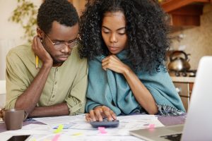 Stressed black couple going over their finances | Wealth connexion blog image