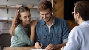 Couple signing paperwork | Wealth Connexion blog image