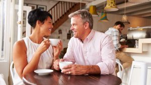 Couple enjoying coffee in a coffee shop | Wealth Connexion blog image