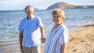 senior couple holding hands at the beach | Wealth Connexion Blog Image
