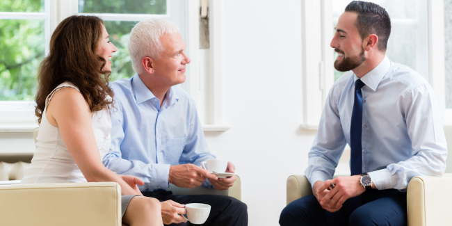 Financial Planner Brisbane Three people sitting in a lounge room talking.